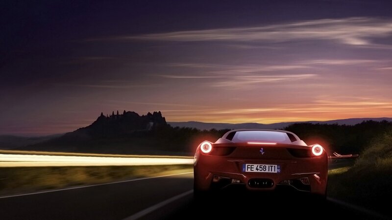 Red Ferrari on a scenic road