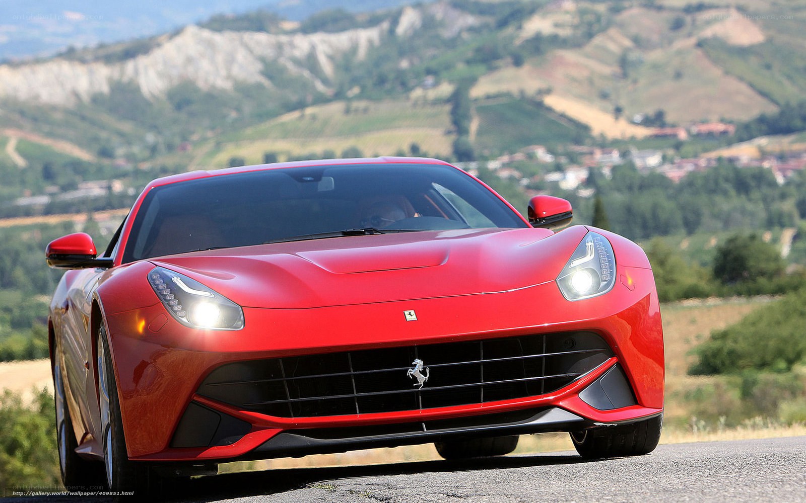 Red Ferrari on a scenic road