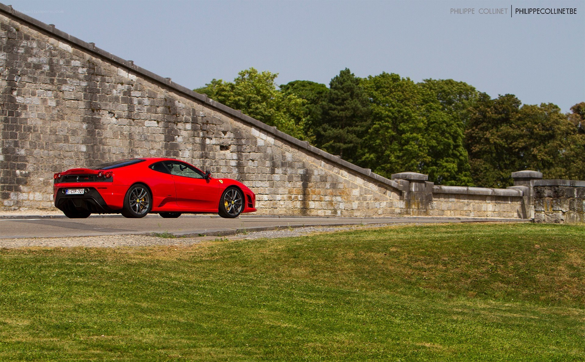 Red Ferrari on a stone bridge