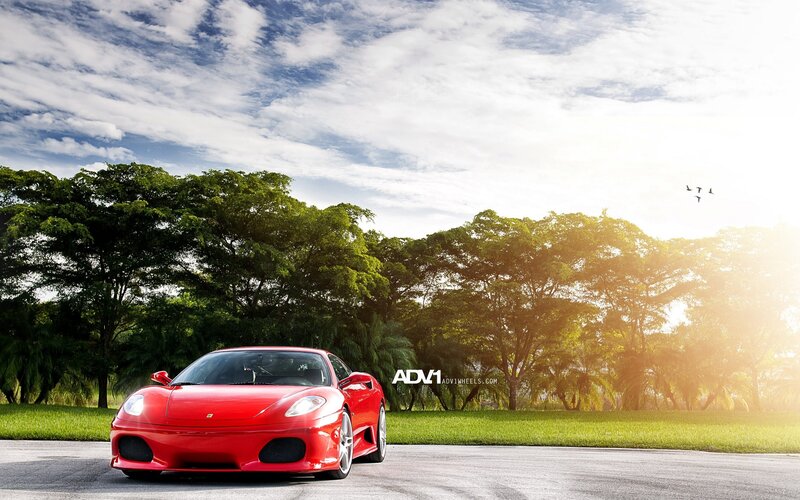 Red Ferrari on a sunny road