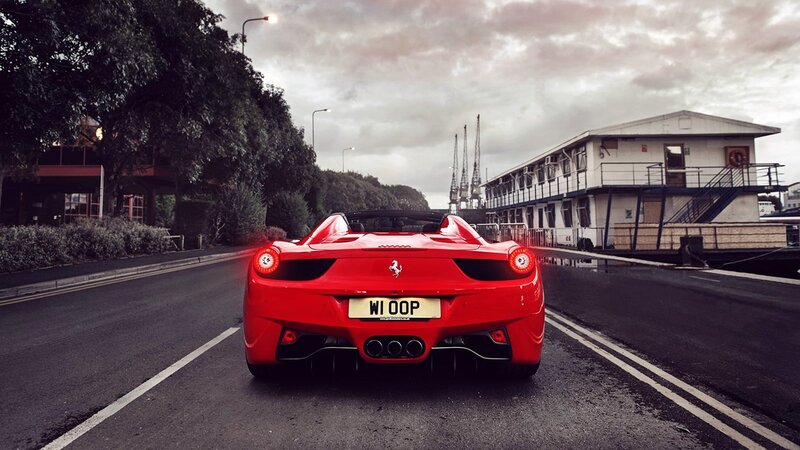 Red Ferrari on a wet road