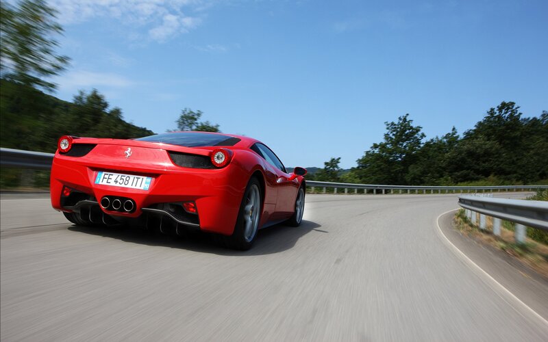 Red Ferrari on a winding road