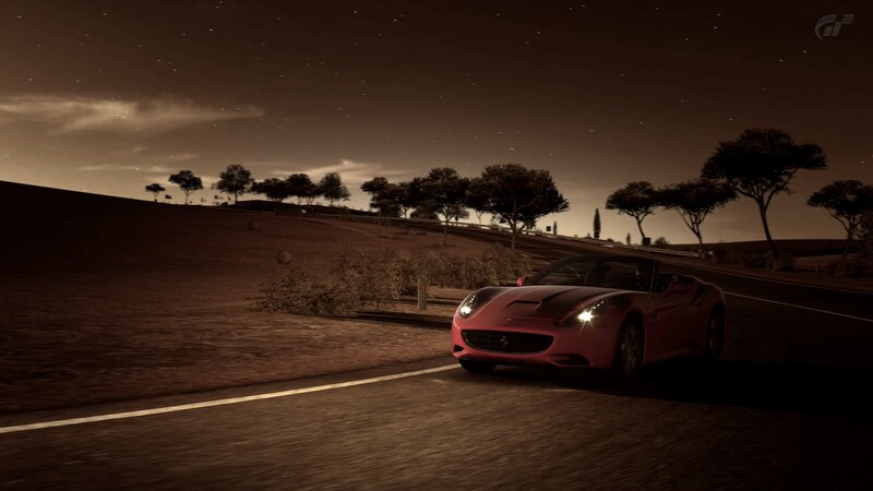 Red Ferrari on a winding road