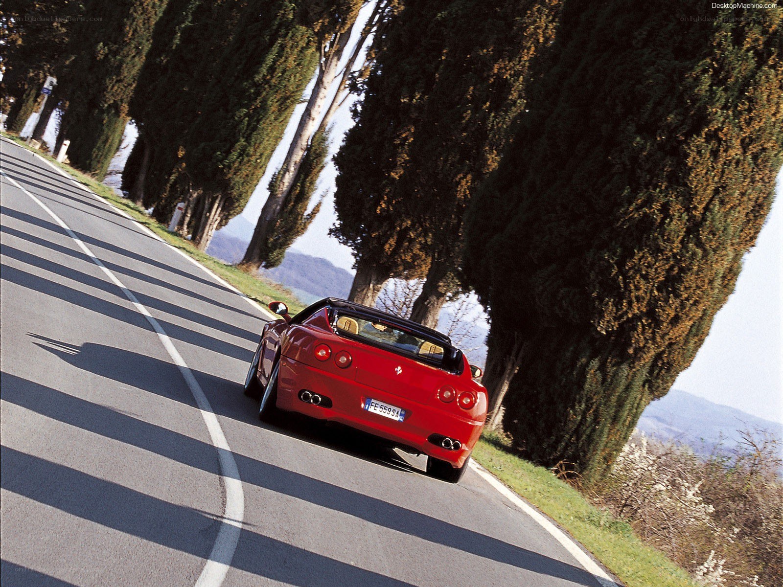 Red Ferrari on a winding road