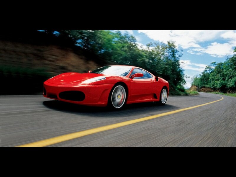 Red Ferrari on a winding road