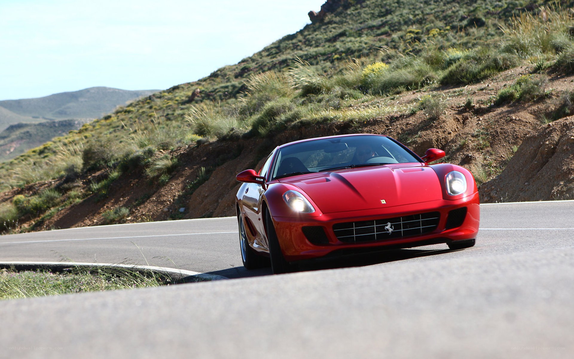 Red Ferrari on a winding road
