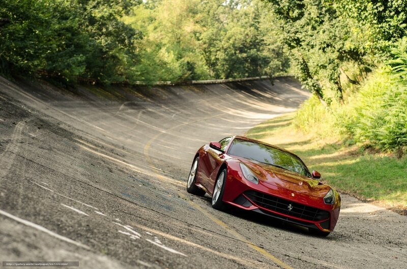 Red Ferrari on a winding road