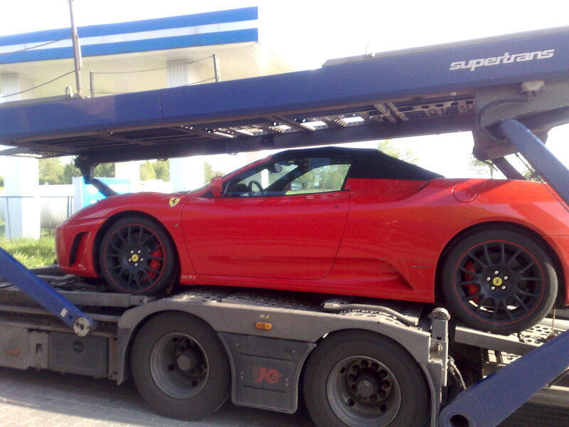 Red Ferrari on car transporter