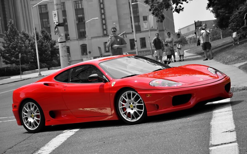 Red Ferrari on city street