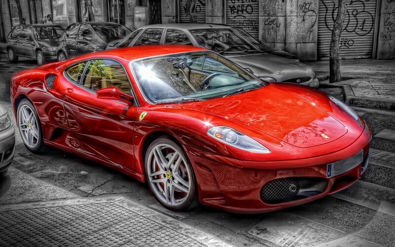 Red Ferrari on city street