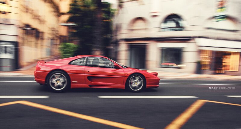 Red Ferrari on city street
