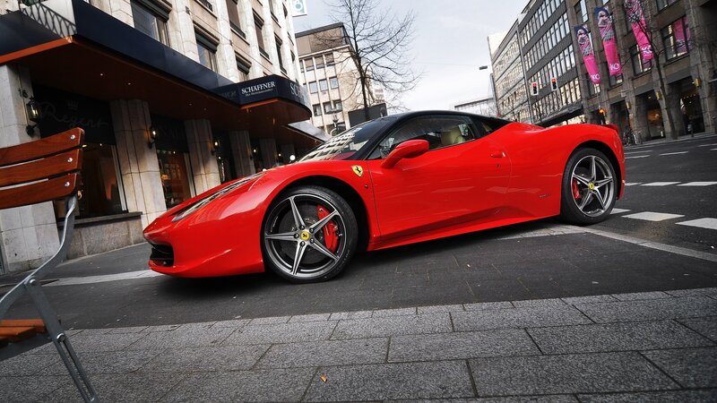 Red Ferrari on city street
