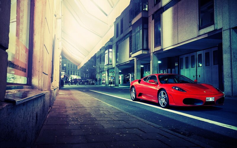 Red Ferrari on city street