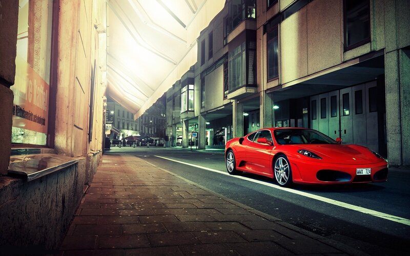 Red Ferrari on city street