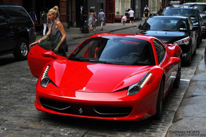 Red Ferrari on city street
