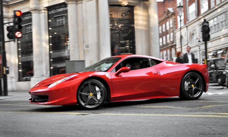 Red Ferrari on city street