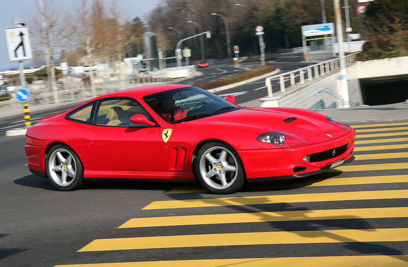 Red Ferrari on city street