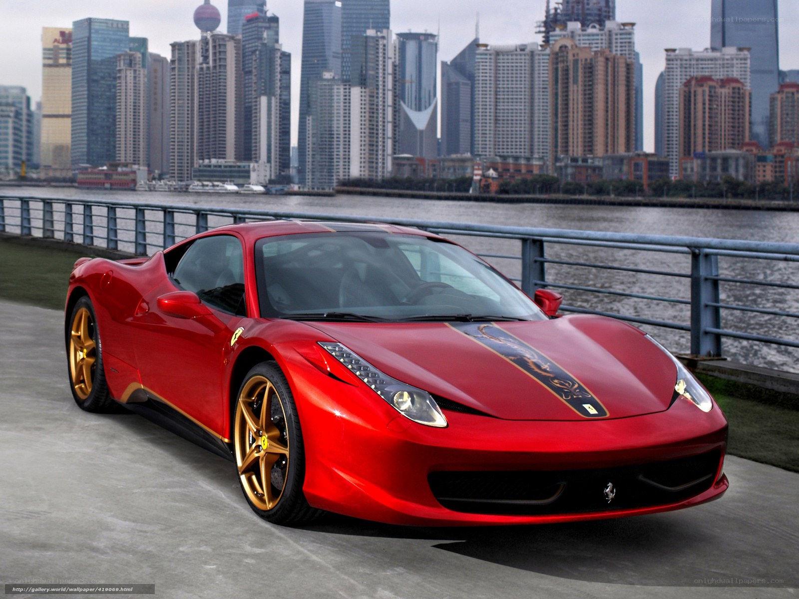 Red Ferrari on city waterfront