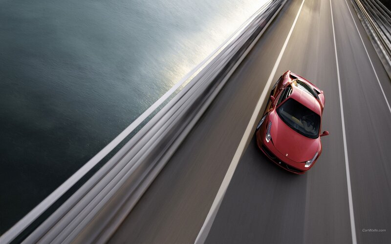 Red Ferrari on coastal road