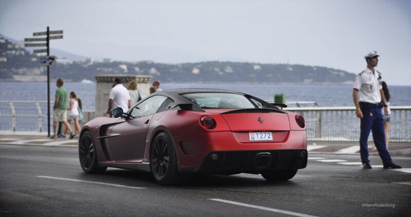 Red Ferrari on coastal road