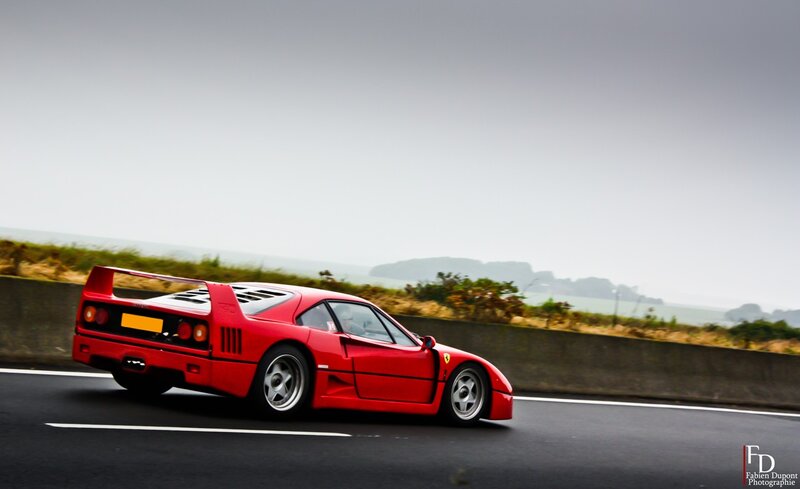 red ferrari on coastal road