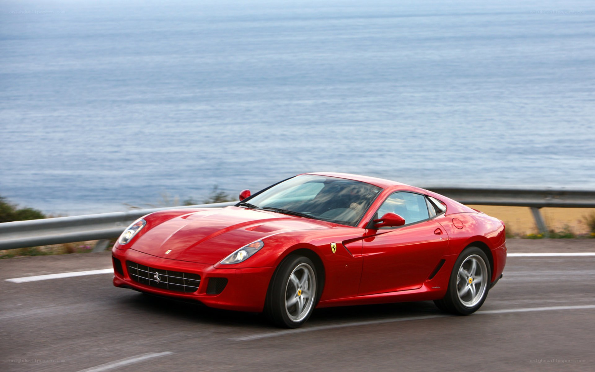 Red Ferrari on coastal road