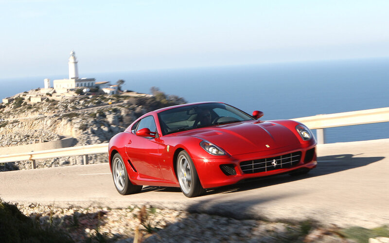 Red Ferrari on coastal road