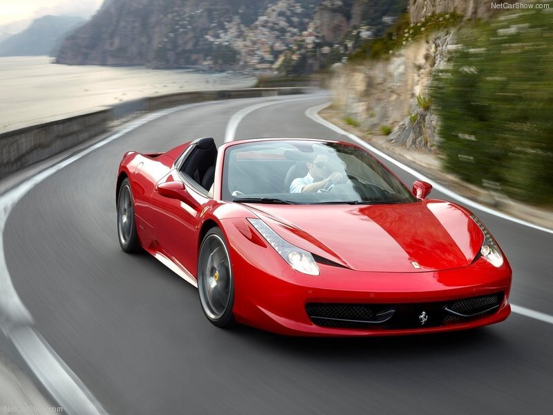 Red Ferrari on coastal road