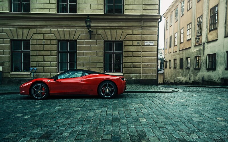 Red Ferrari on cobblestone street