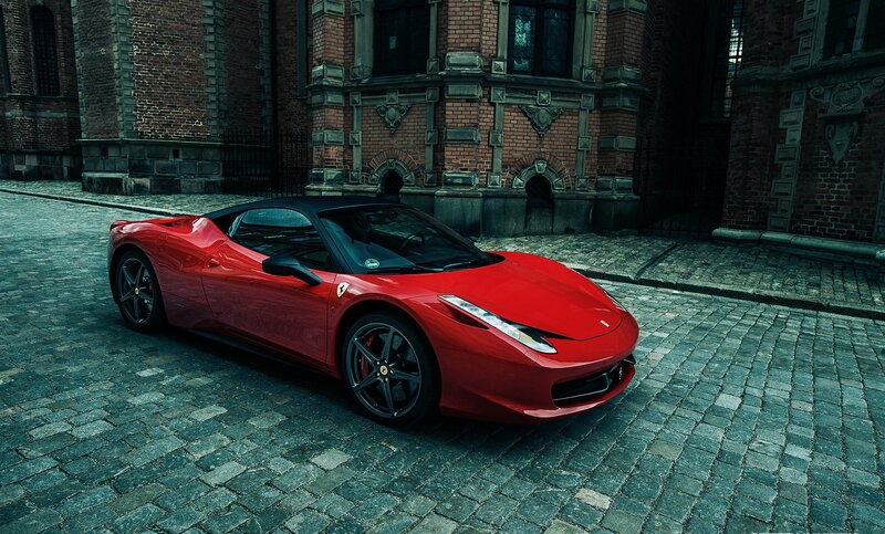 Red Ferrari on cobblestone street