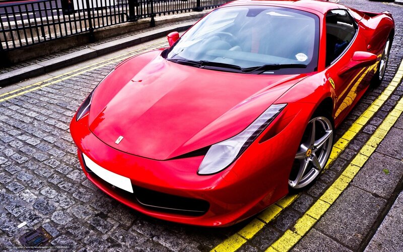 Red Ferrari on cobblestone street