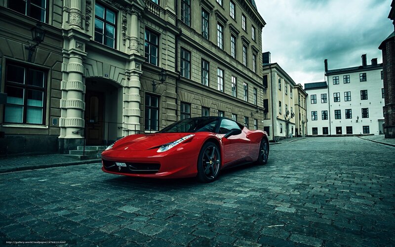 Red Ferrari on cobblestone street