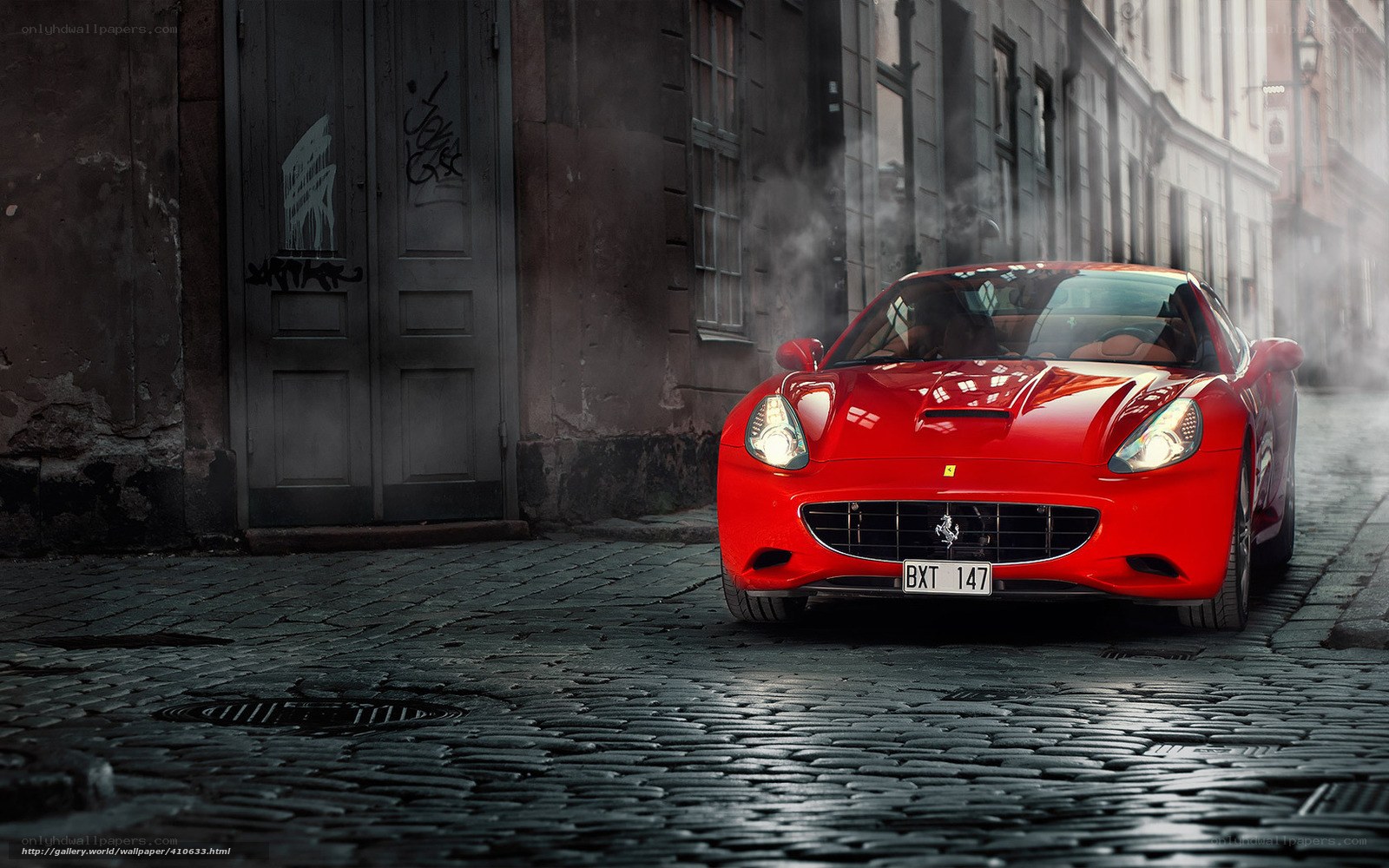 Red Ferrari on cobblestone street