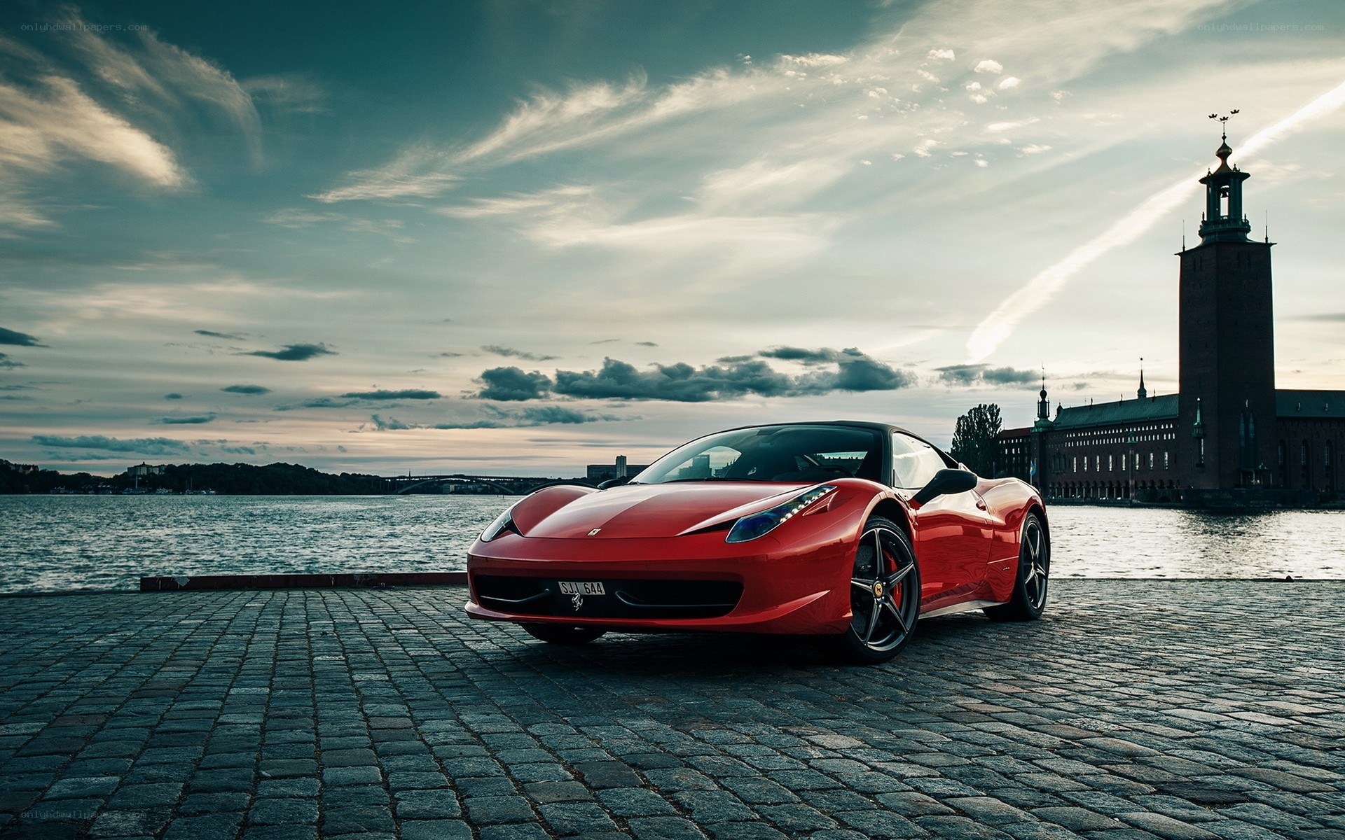 Red Ferrari on cobblestones