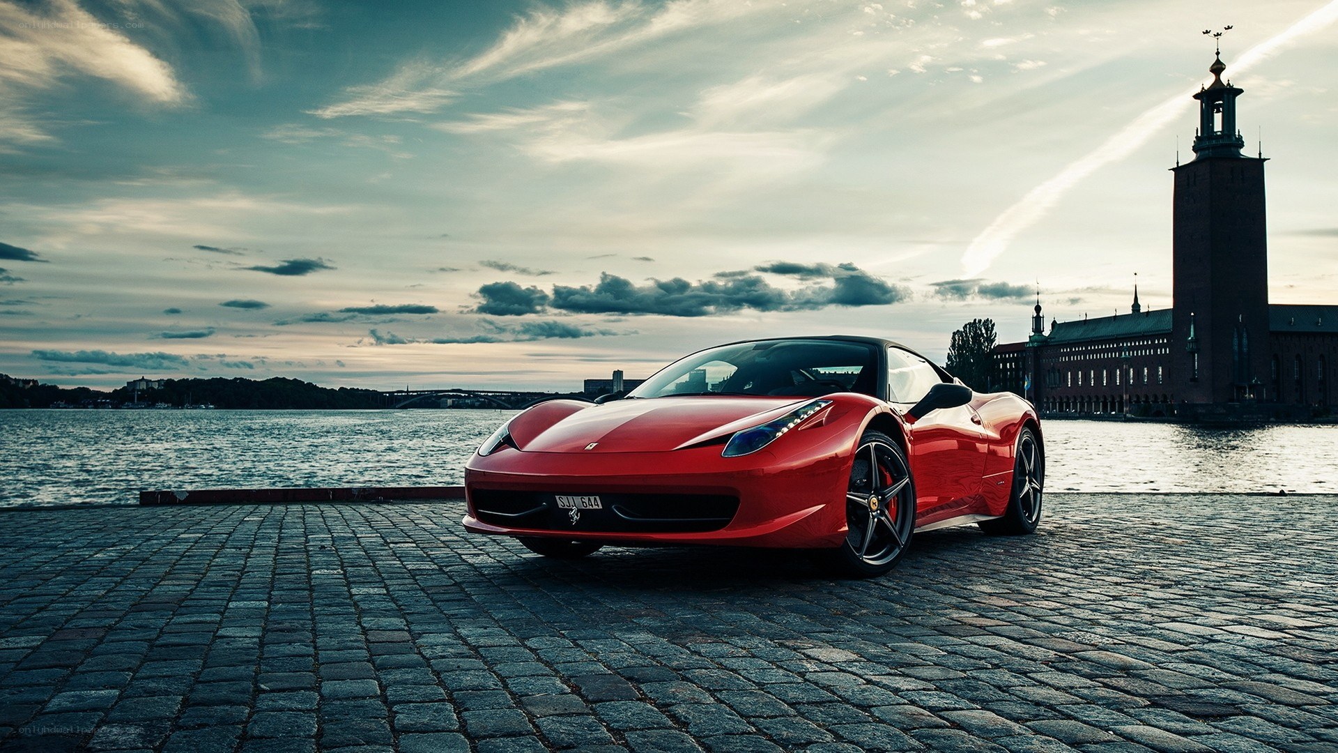 Red Ferrari on cobblestones