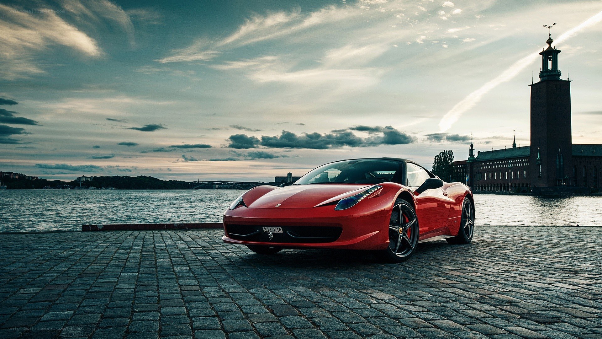 Red Ferrari on cobblestones