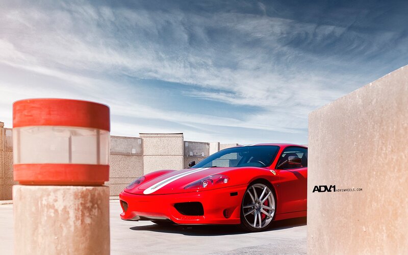 Red Ferrari on concrete lot