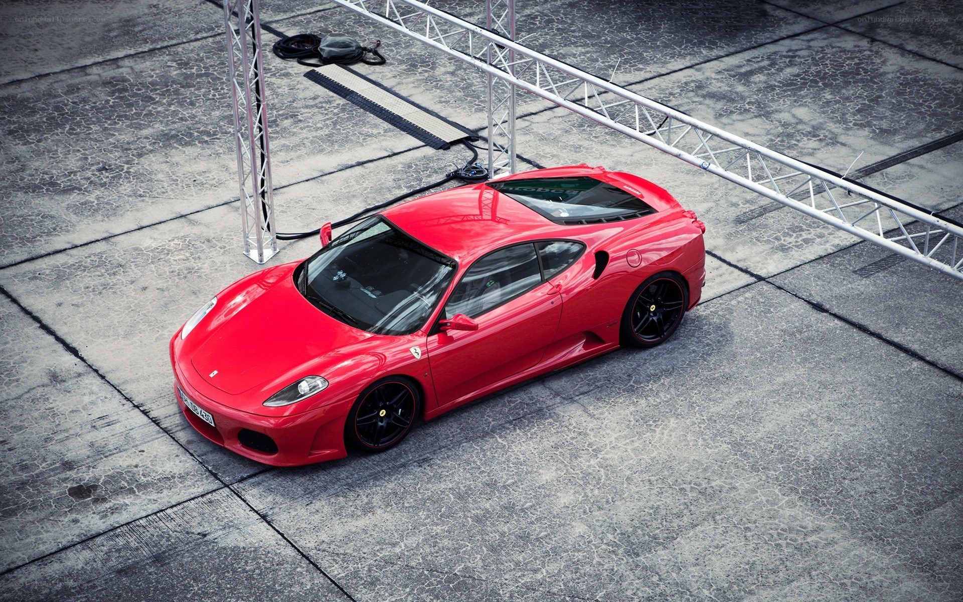 Red Ferrari on concrete surface