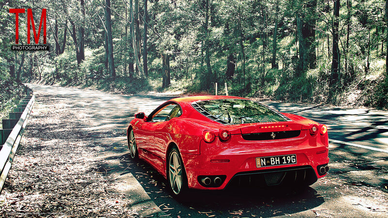 Red Ferrari on forest road