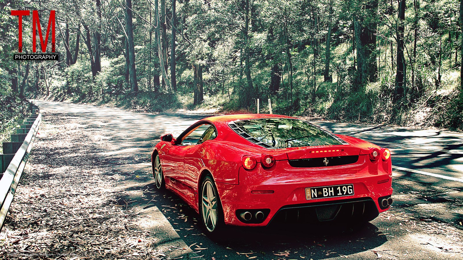 Red Ferrari on forest road