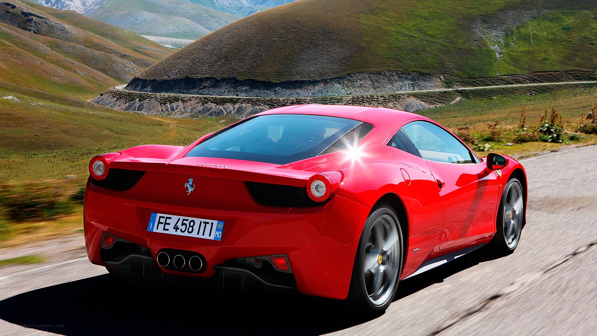 Red Ferrari on mountain road