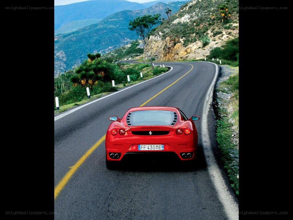 Red Ferrari on mountain road