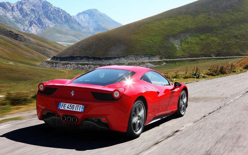 Red Ferrari on mountain road