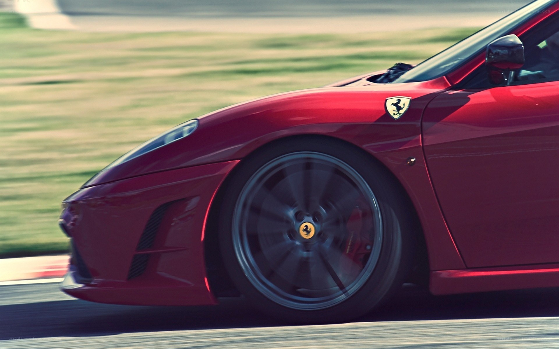 red ferrari on racetrack