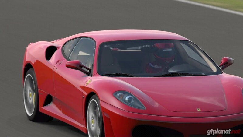 red ferrari on racetrack