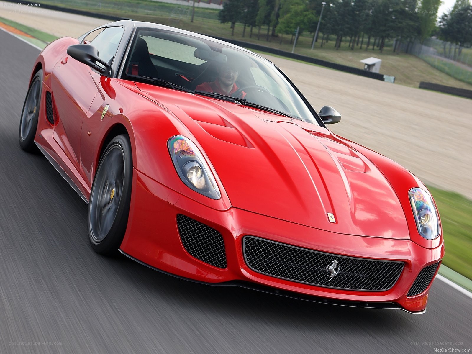 red ferrari on racetrack