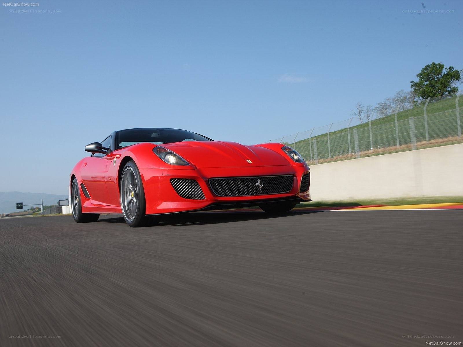 red ferrari on racetrack