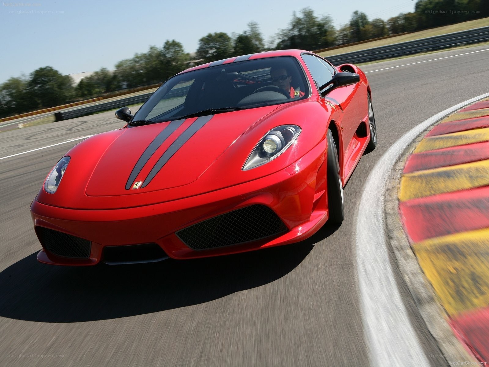 Red Ferrari on racetrack