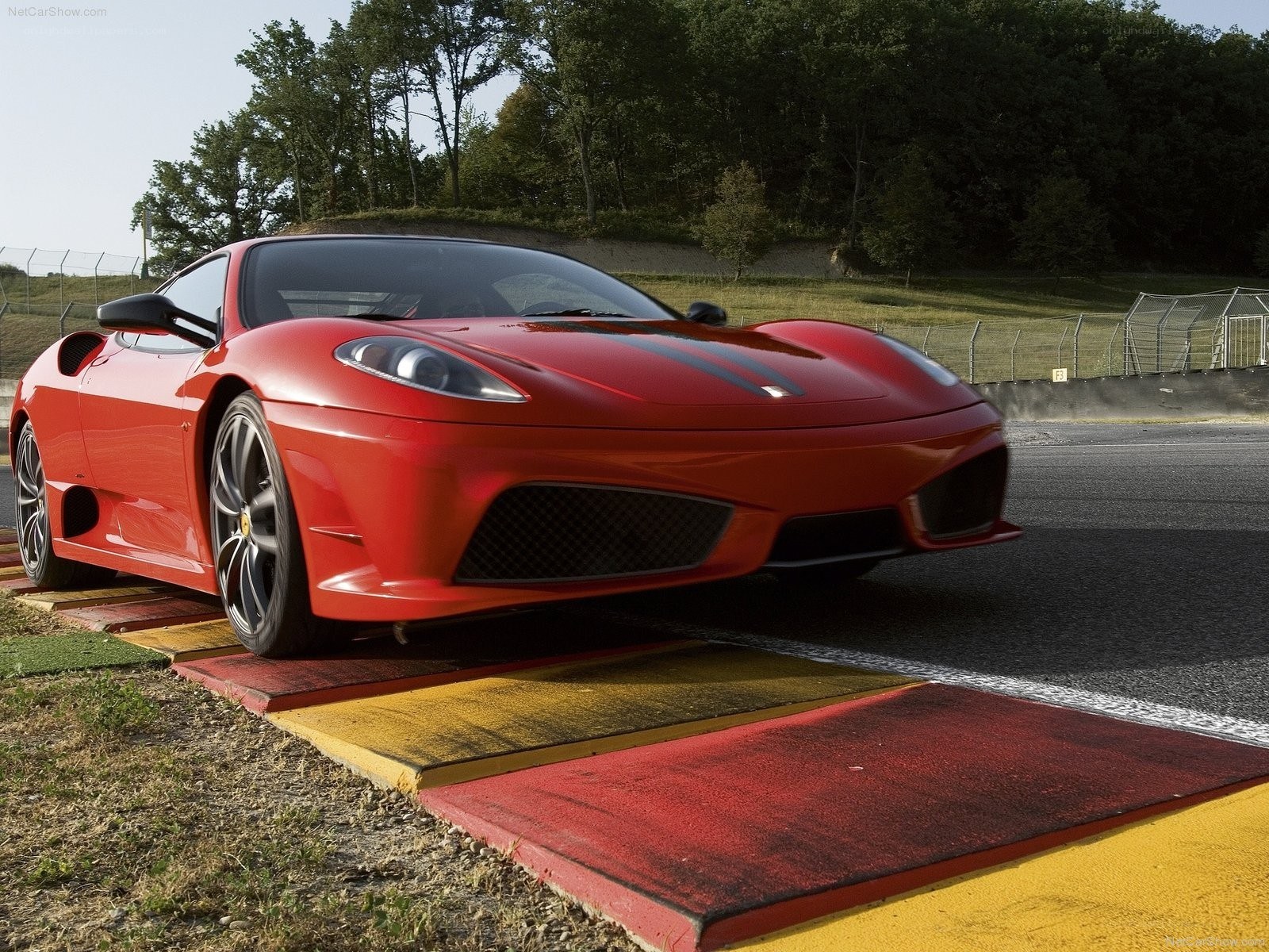 Red Ferrari on racetrack