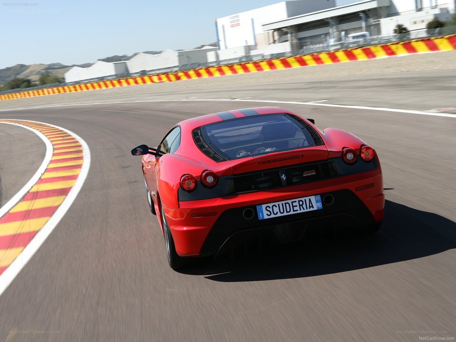 Red Ferrari on racetrack
